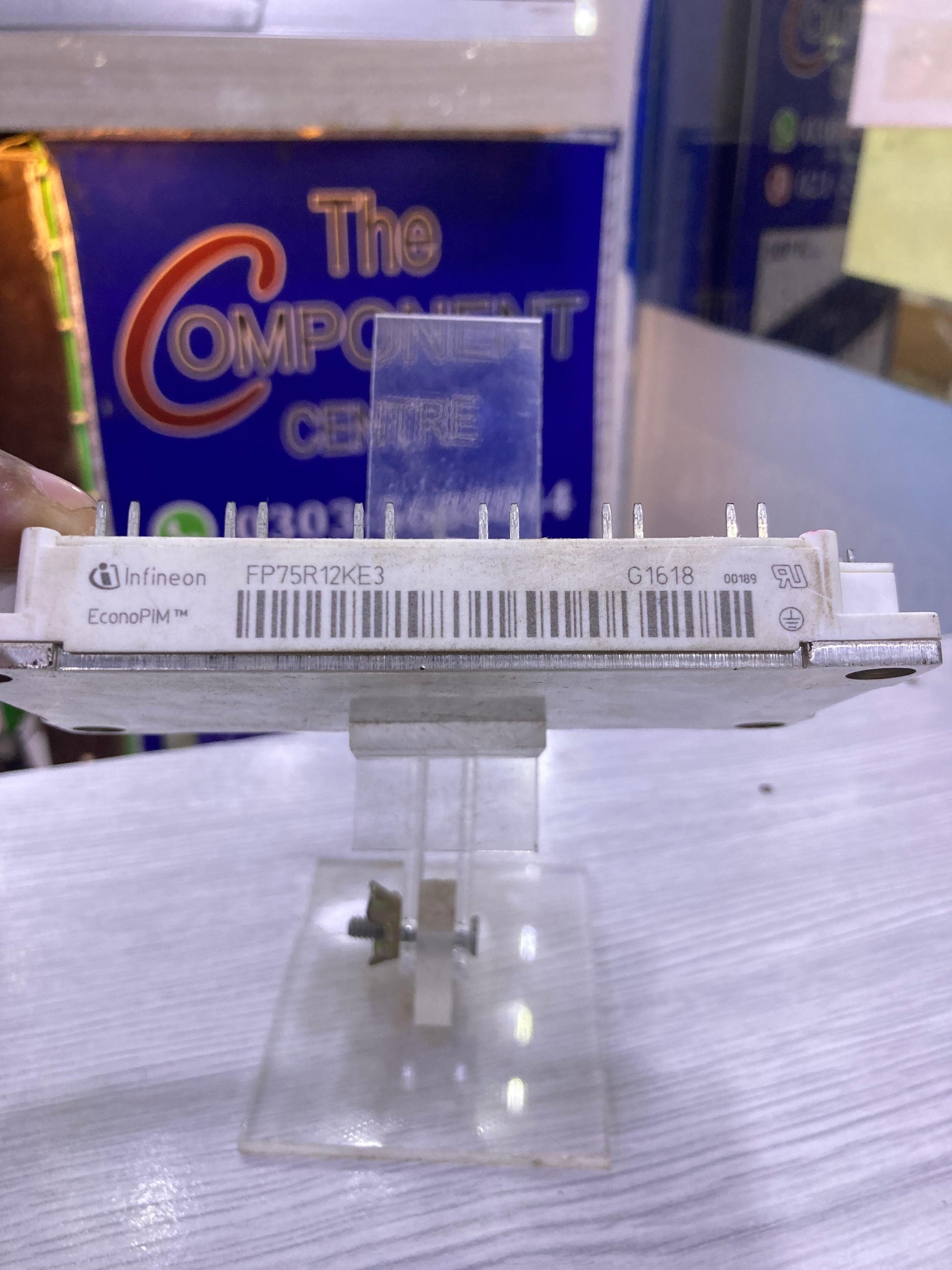 Infineon FP75R12KE3 power module displayed on a clear stand at The Component Centre