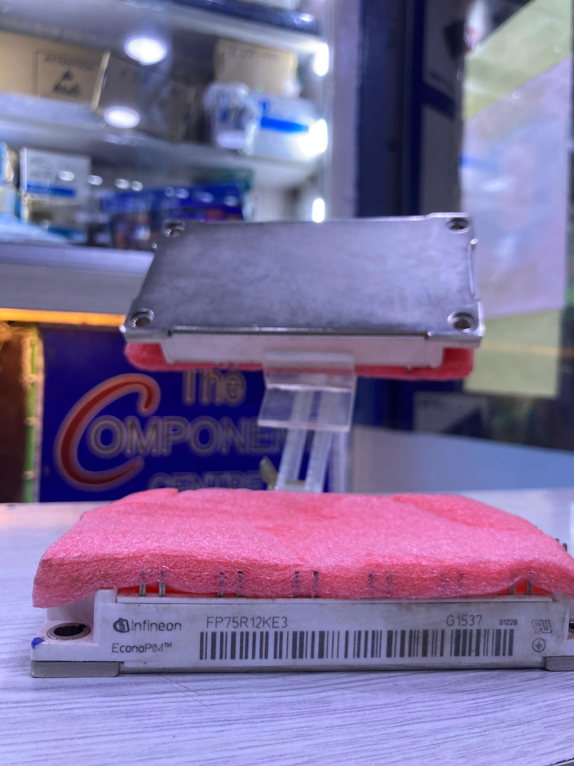 Infineon FP75R12KE3 power module with protective foam on a table at The Component Centre