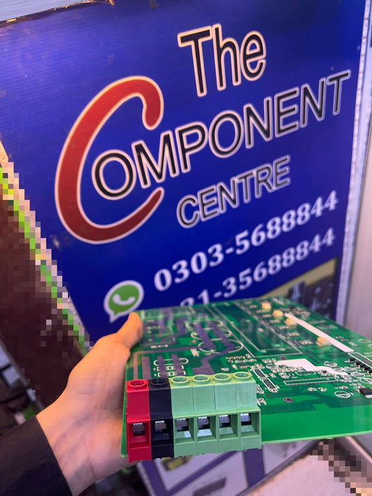 Hand holding KF136 green printed circuit board PCB with connectors in front of The Component Centre sign
