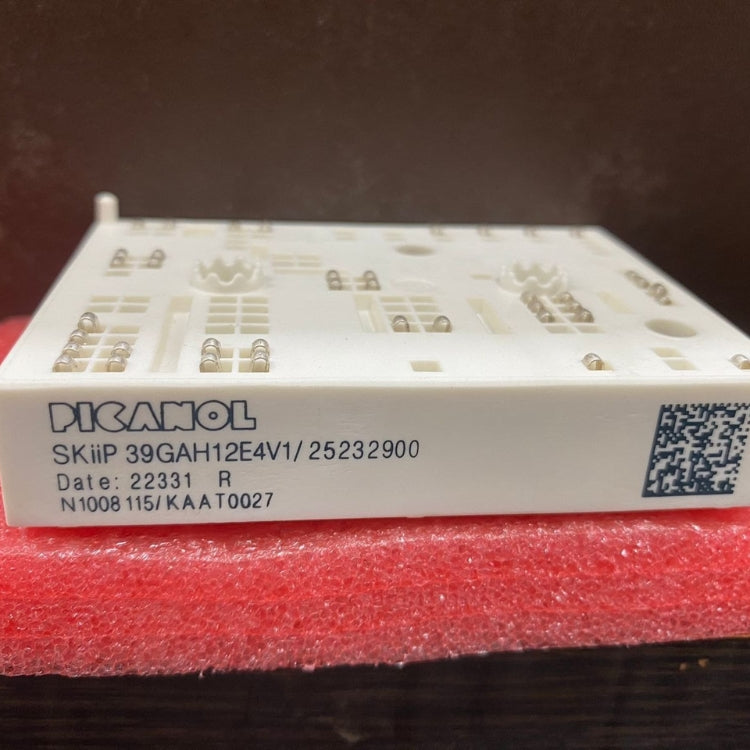 Picanol power module SKiiP39GAH12E4V1 resting on red foam showing white ceramic housing and label
