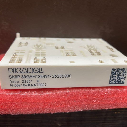 Picanol power module SKiiP39GAH12E4V1 resting on red foam showing white ceramic housing and label