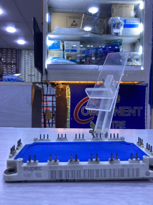 BSM75GD120DN2 power module by The Component Centre with multiple pins on a blue surface