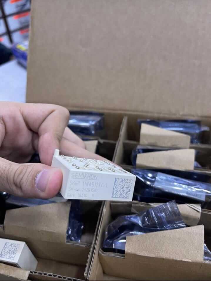 SKiiP 11NAB126V1 Module from The Component Centre, shown in a hand with multiple packages nearby