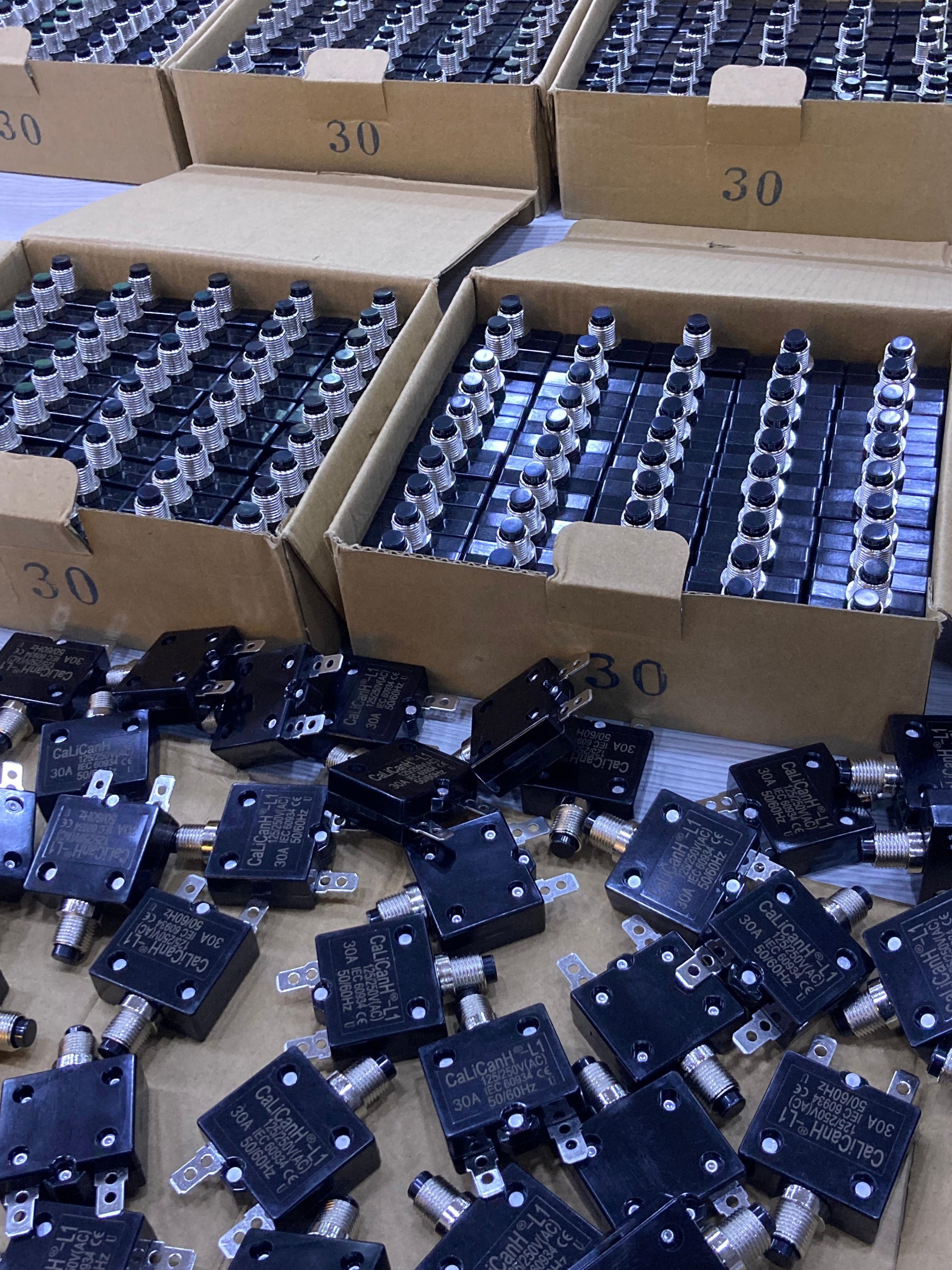 Bulk Calicanh-L1 125/250V thermal cutoff switches and terminal blocks packed in cardboard trays for repairs