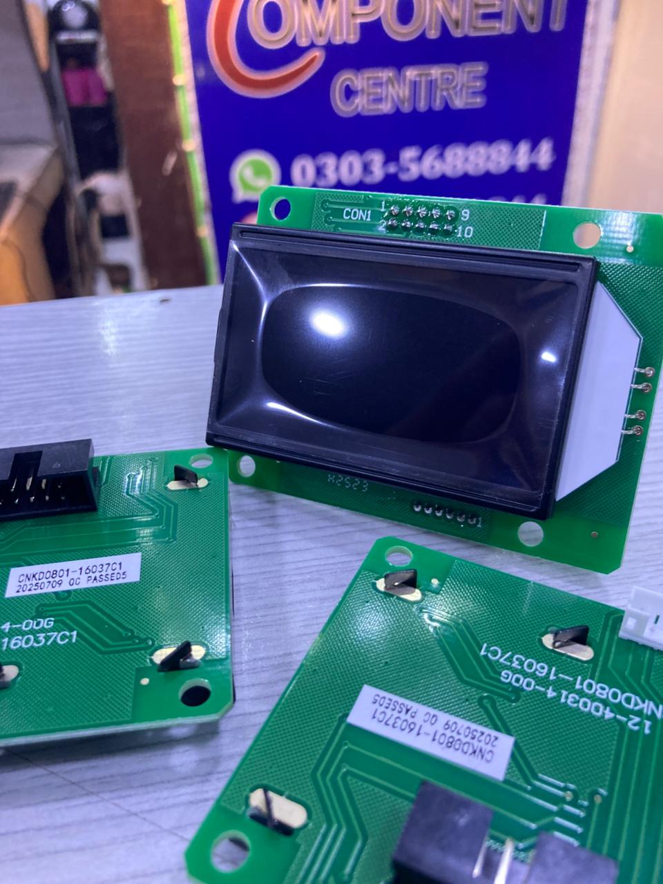 JDA0801-16037C1 LCD module mounted on green circuit board shown with multiple PCBs and The Component Centre sign