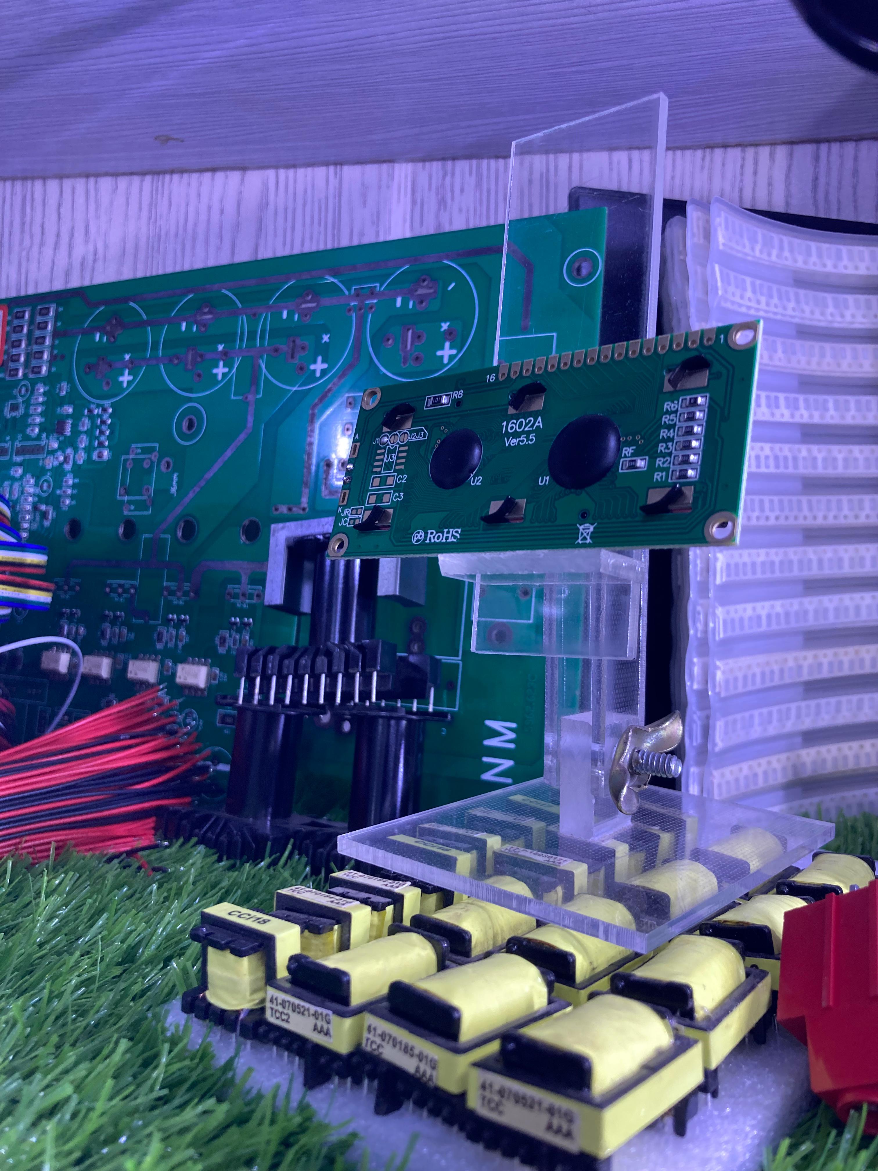16x2 Blue LCD display module mounted on a green circuit board with electronic components