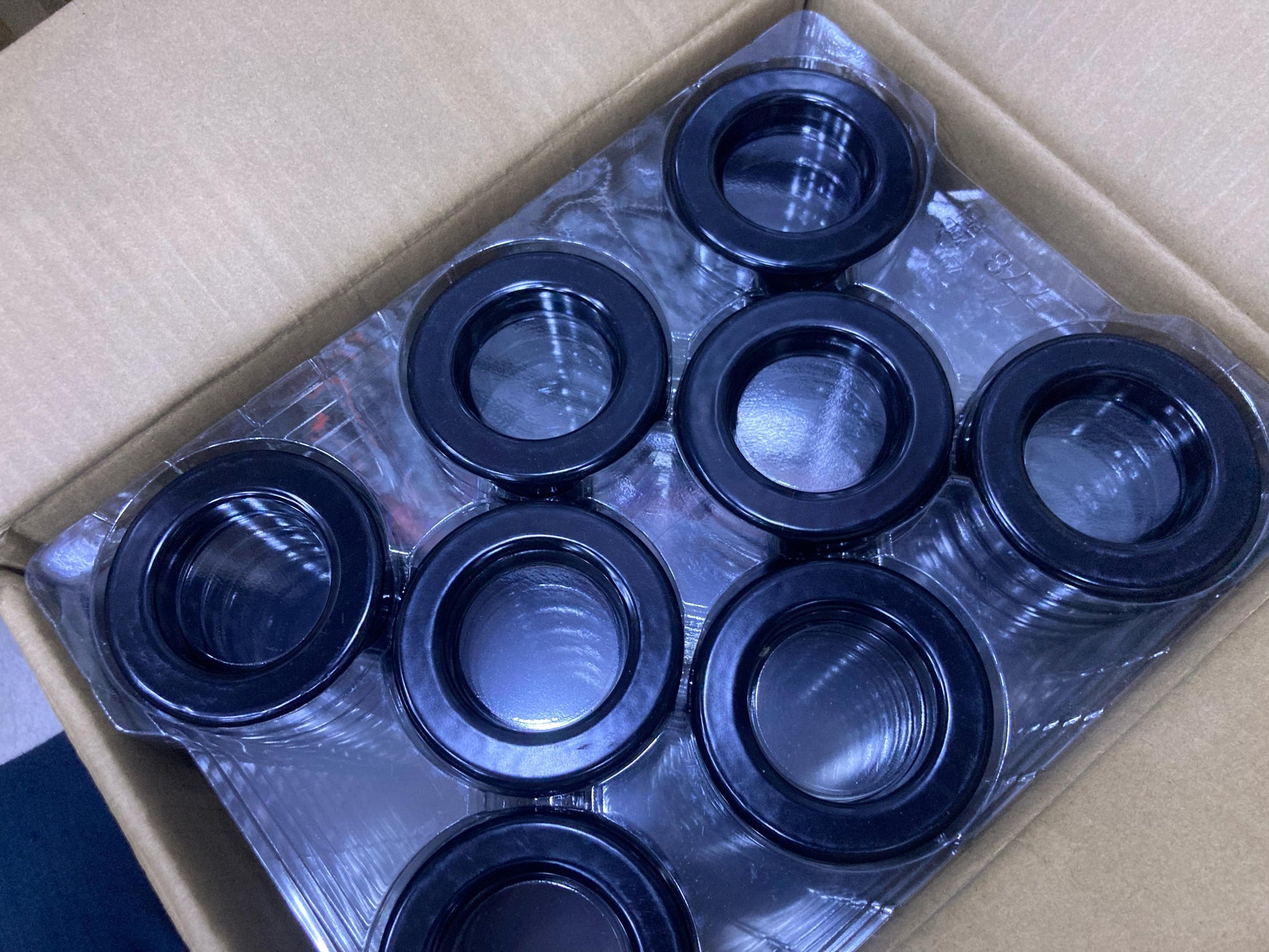 Box containing multiple black 3 Inch Ferrite Ring components from The Component Centre