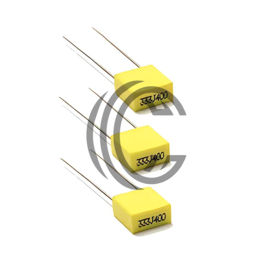 Three yellow 104J100 0.1uF capacitors with long metal leads from The Component Centre