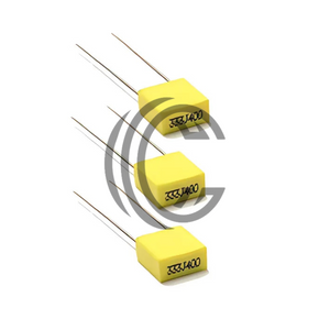 Three yellow 104J100 0.1uF capacitors with long metal leads from The Component Centre