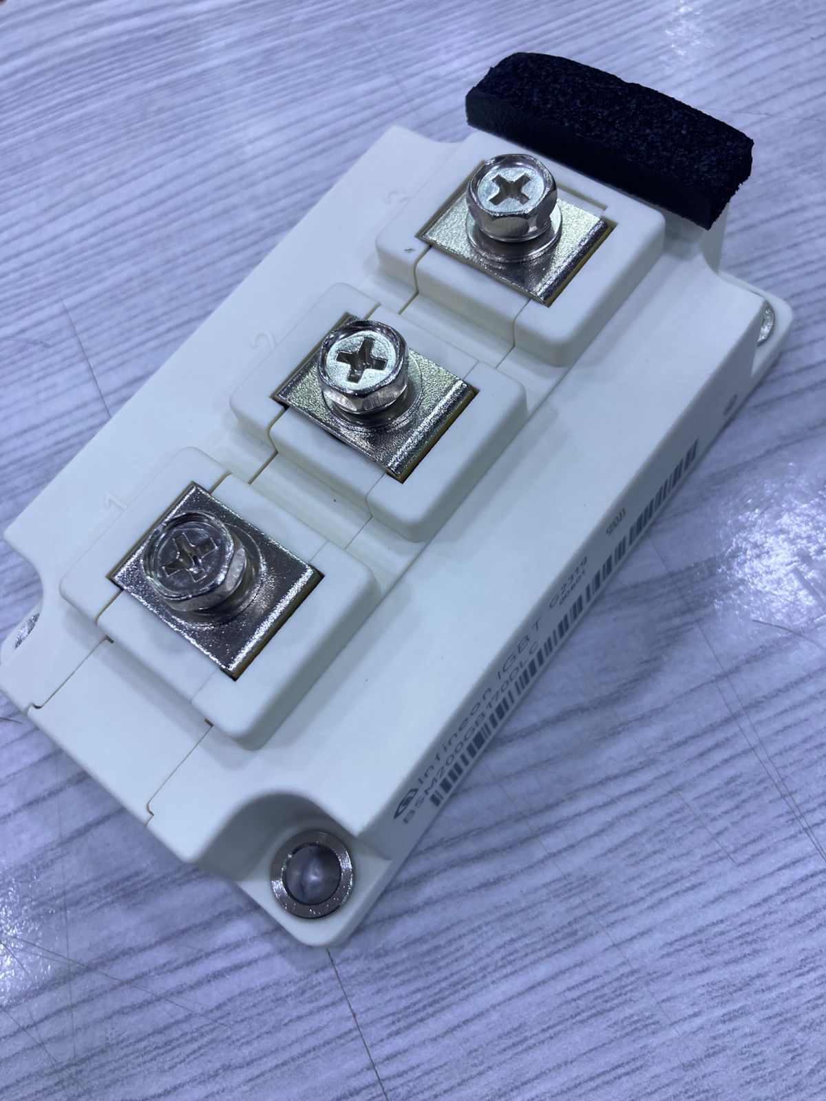 BSM200GB170DLC white power semiconductor module with three screw terminals and mounting hole for power electronics