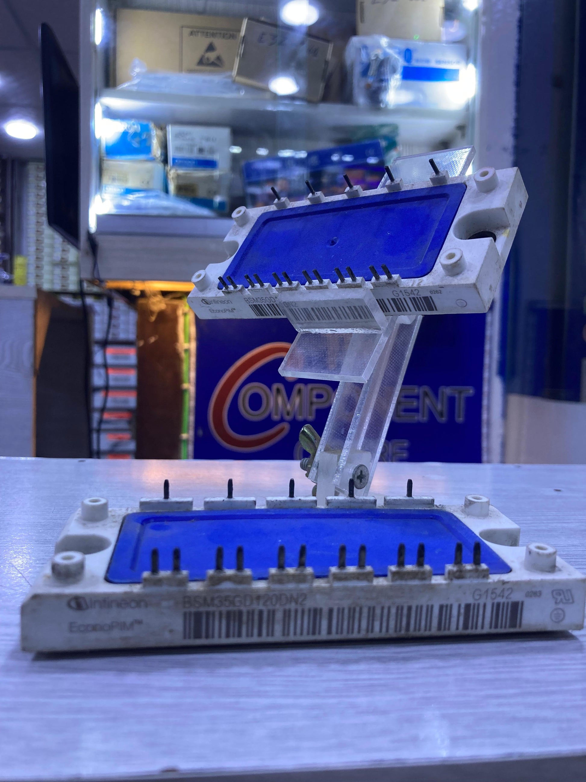 The Component Centre BSM35GD120DN2 electronic power module with blue protective covers on pins