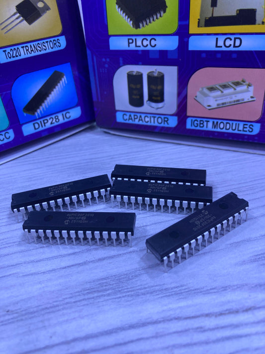 dsPIC30F2010 microcontroller chips from The Component Centre arranged on a surface with electronic component diagrams in the background