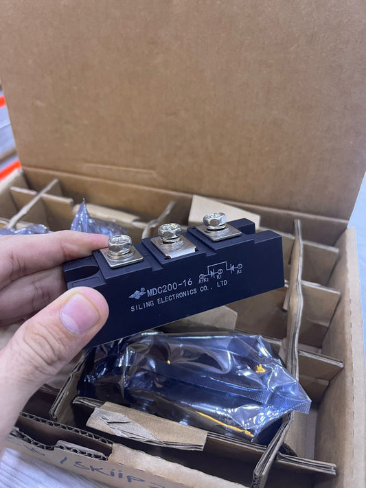 MDC200-16 Module held in hand with three connectors for electrical applications