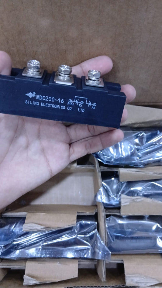 MDC200-16 Power Module held in hand with multiple connectors for electronic applications