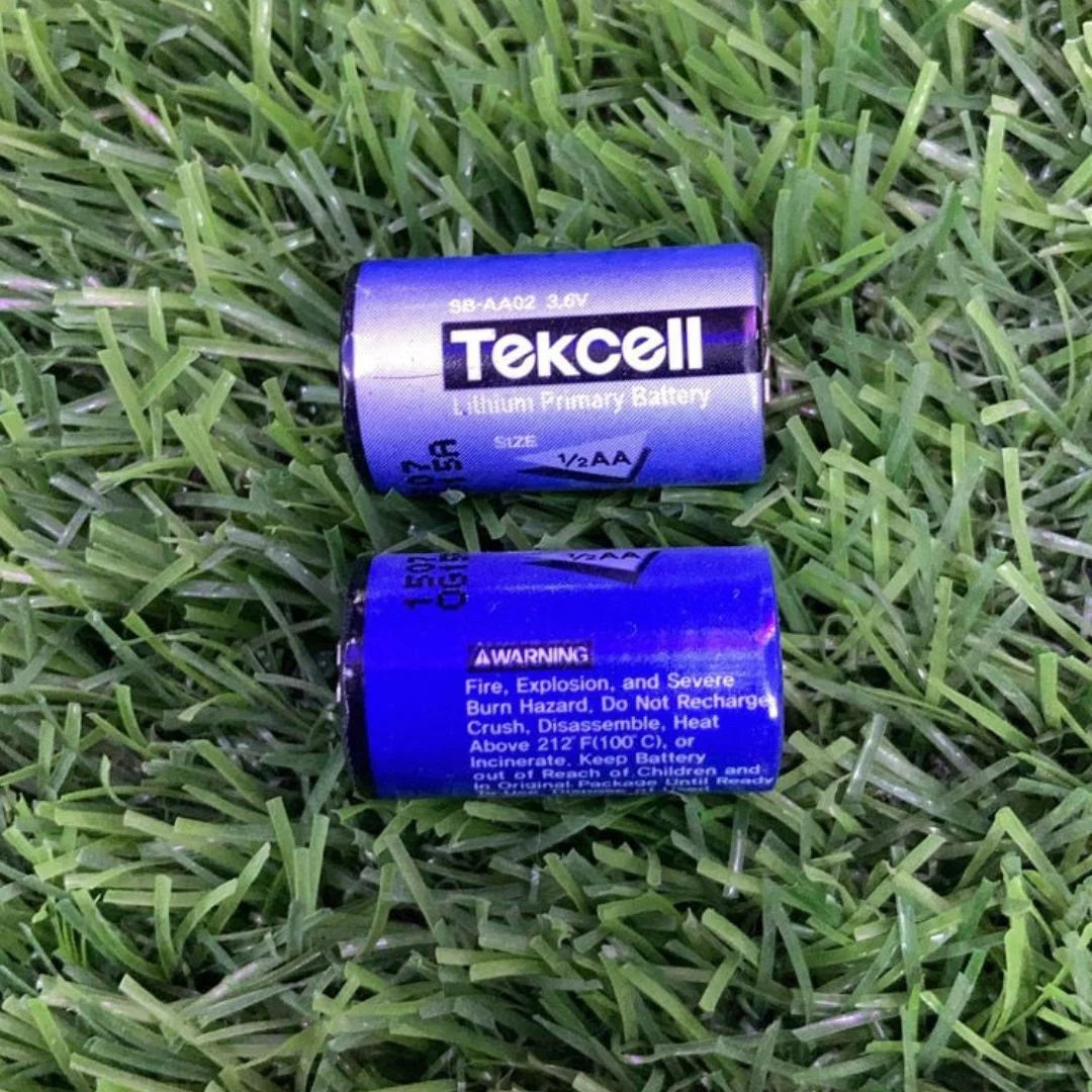 Tekcell lithium primary batteries size 1/2 AA with SB-AA02 model number placed on green grass