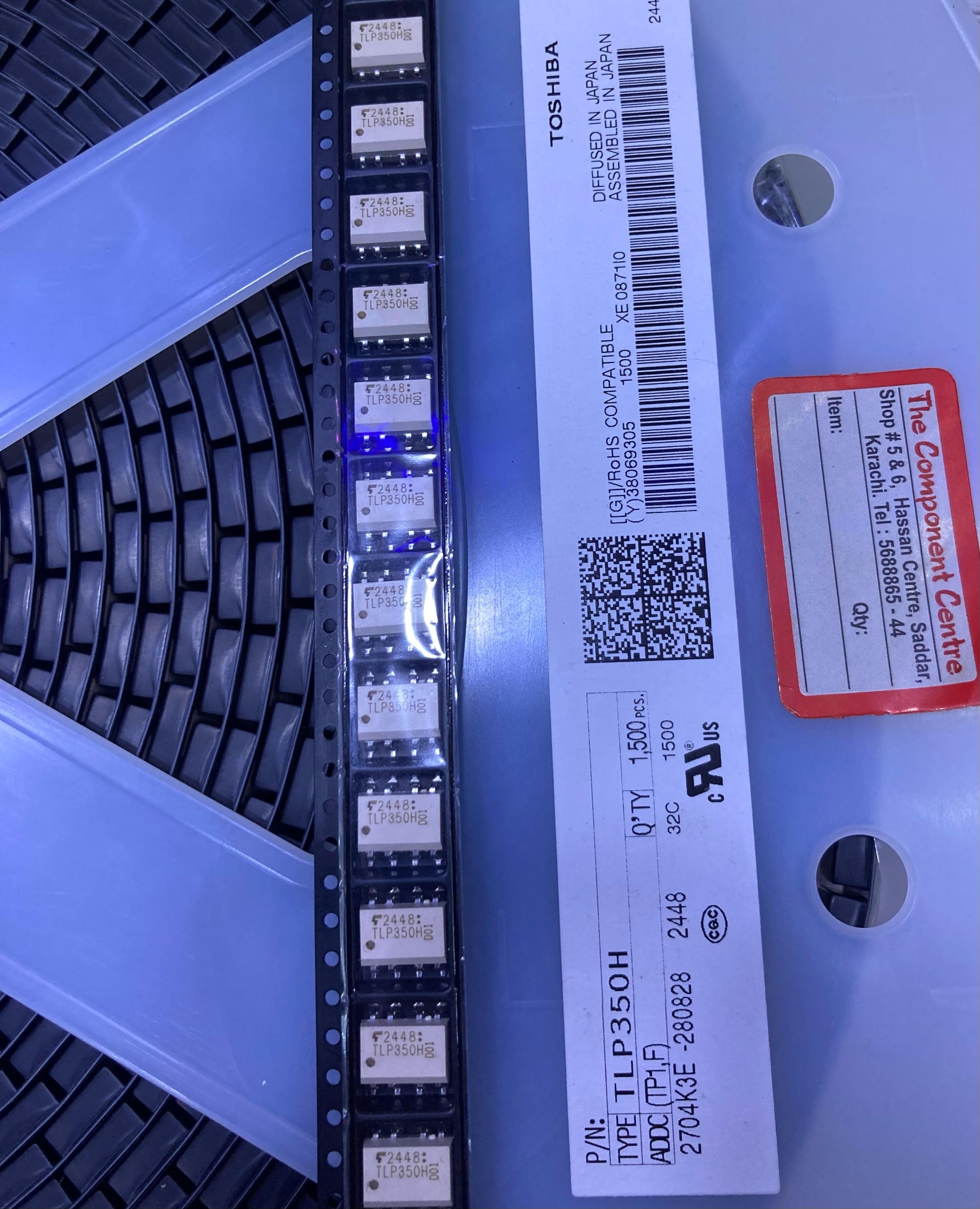 TLP350H electronic components reel from The Component Centre with labeled packaging and multiple small chips